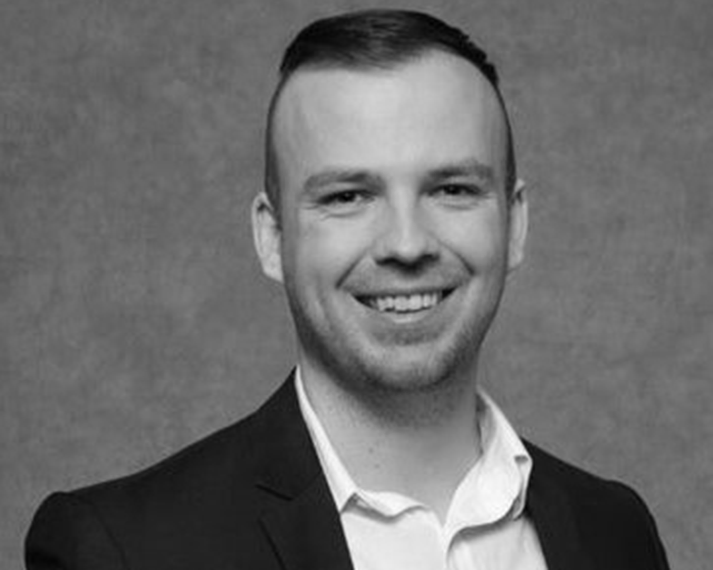 Black and white headshot photo of Dr. Christopher Hughes